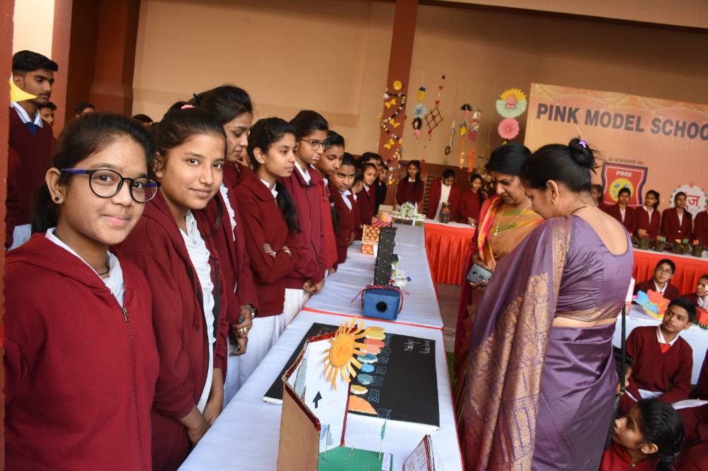 Students presenting projects at Pink Model School assembly